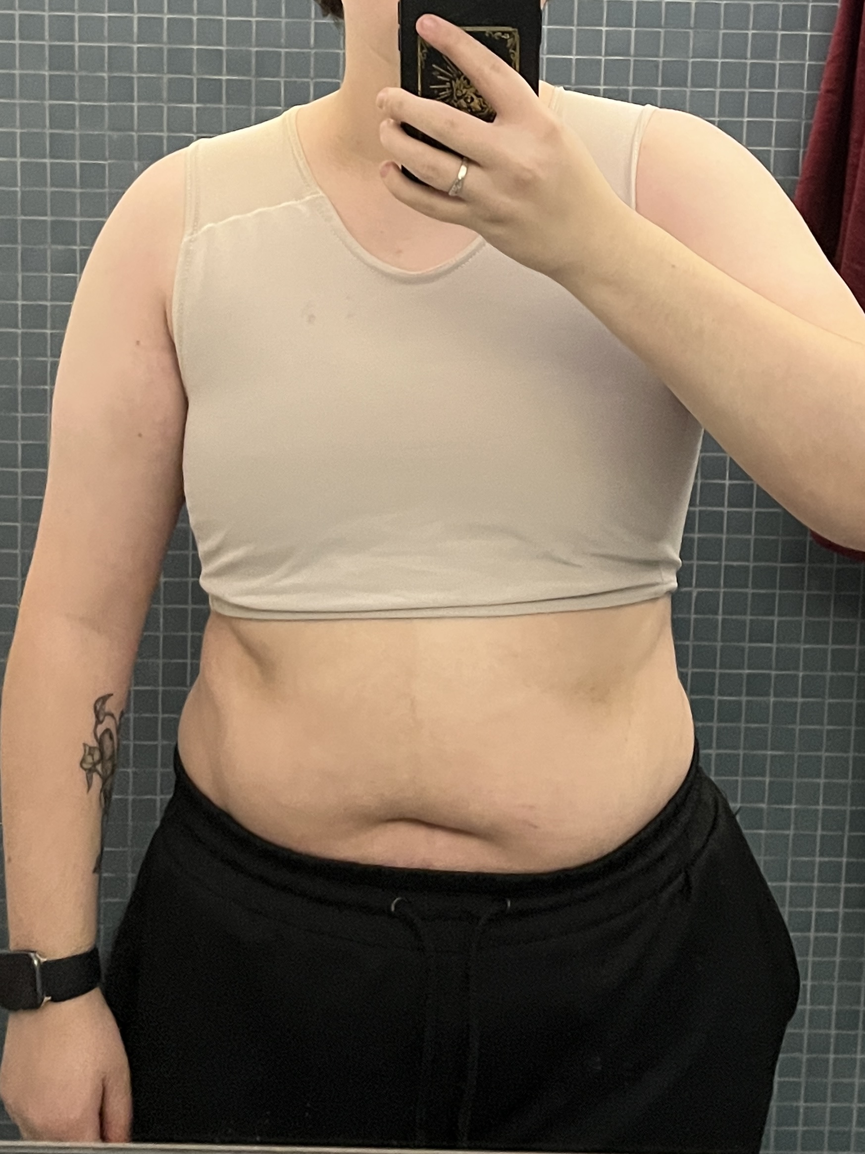 Trans man wearing a tan half binder